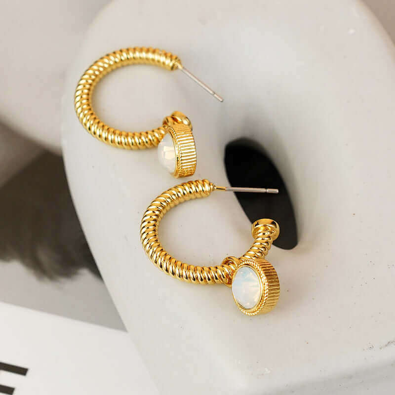 Rope Cat's Eye Stone C-Hoop Earrings in gold-plated copper material, displayed on a light gray surface.