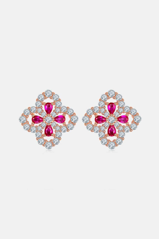 Sterling silver flower-shaped stud earrings with lab-grown rubies.