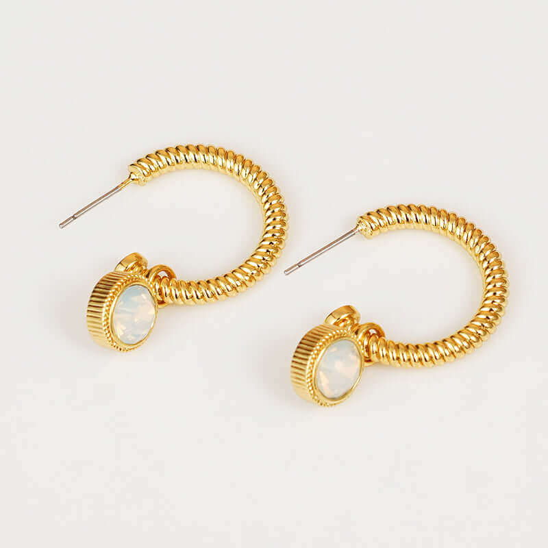 Gold-plated rope style C-hoop earrings with cat's eye stone charm, made of copper, displayed on a light background.