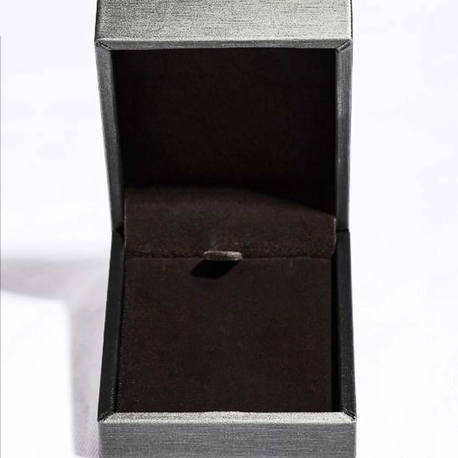 Empty jewelry box with velvet interior designed for a necklace, displayed open on a white background.