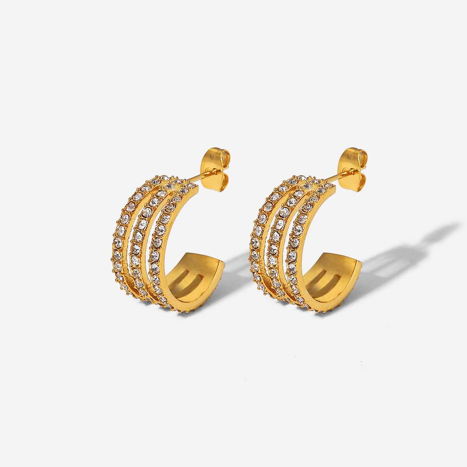 Stainless steel inlaid zircon C-hoop earrings with gold-plated finish, featuring sparkling gemstones on a white background.