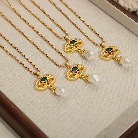 Freshwater pearl titanium steel geometric necklaces with gold-plated chains and green and pearl pendant accents displayed in a jewelry box.