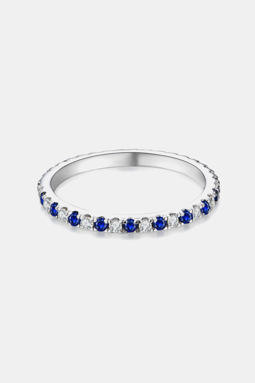 Minimalist moissanite and lab-grown sapphire ring in platinum-plated 925 sterling silver.