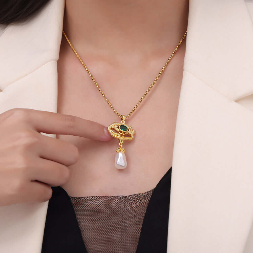 Woman wearing a Freshwater Pearl Titanium Steel Geometric Necklace with gold-plated details and green glass gemstone.