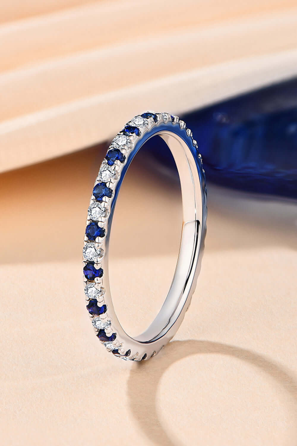 Minimalist moissanite lab-grown sapphire ring in 925 sterling silver and platinum-plated setting, perfect for elegant occasions.