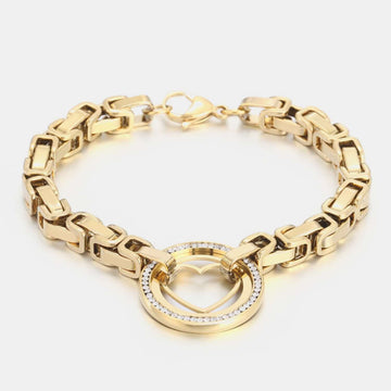 Gold-plated stainless steel bracelet with zircon heart cutout design, showcasing intricate chain links and a central heart ornament.