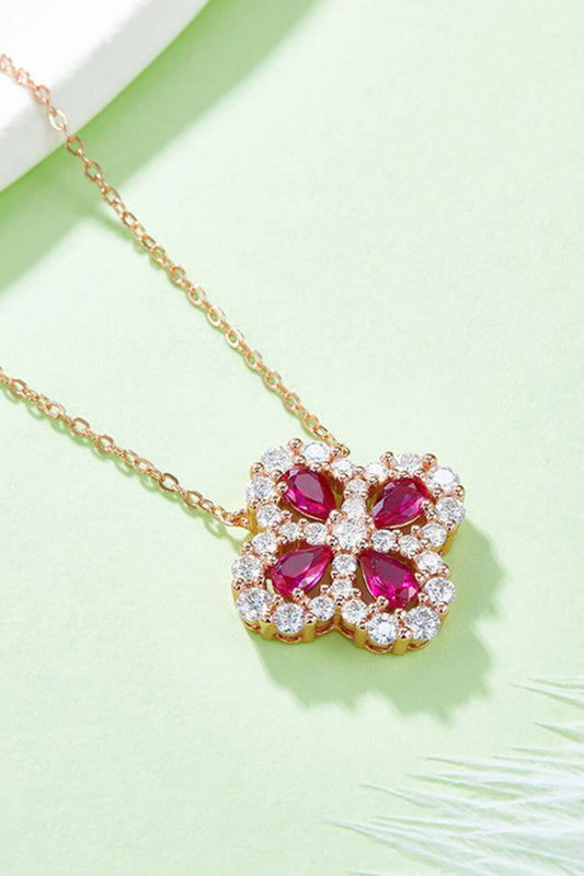 Sterling silver necklace with lab-grown ruby flower pendant on a delicate chain.