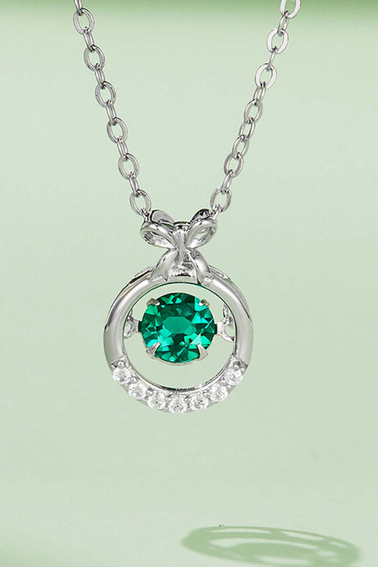 Modern platinum-plated sterling silver necklace with lab-grown emerald pendant and zircon accents, highlighting luxurious design.