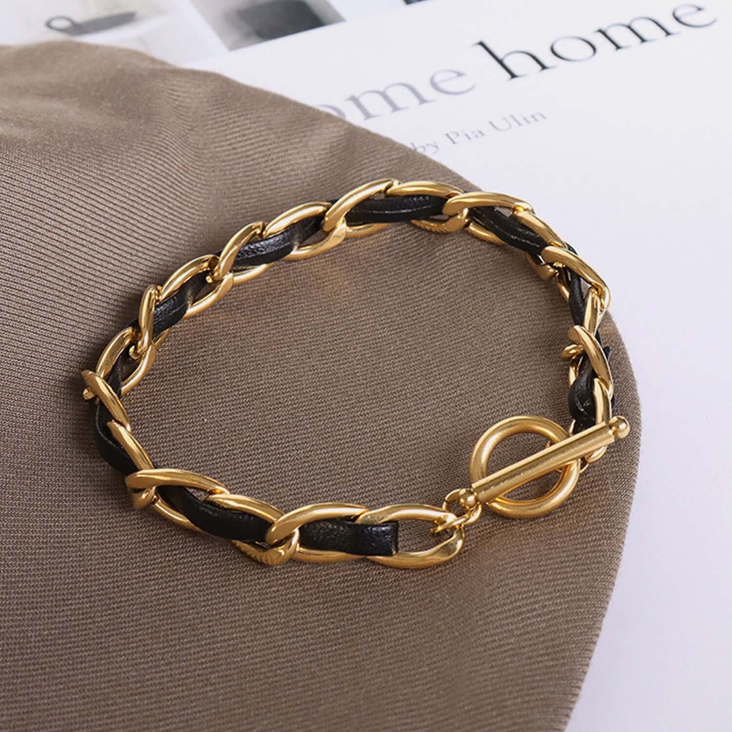 18K gold-plated leather chain bracelet with toggle clasp, featuring a luxurious design perfect for elegant and sophisticated styling.