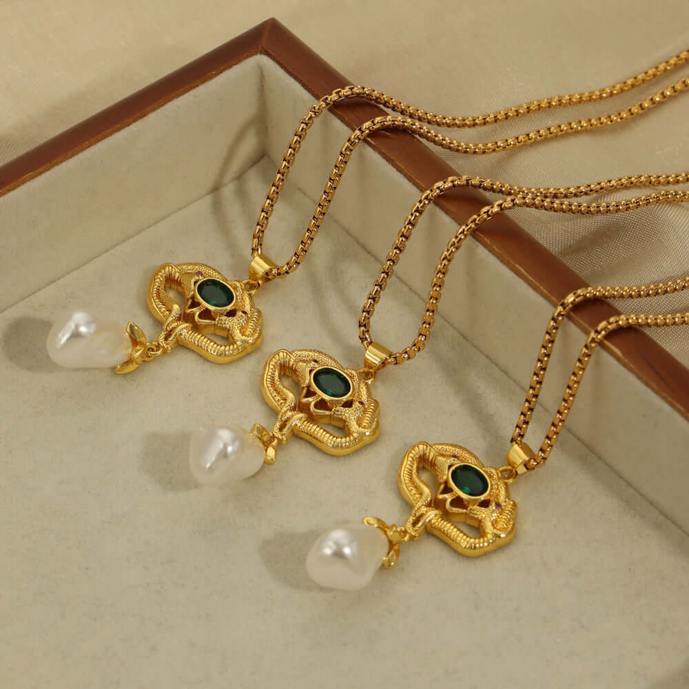 Gold-plated geometric necklaces with freshwater pearl pendants in jewelry box