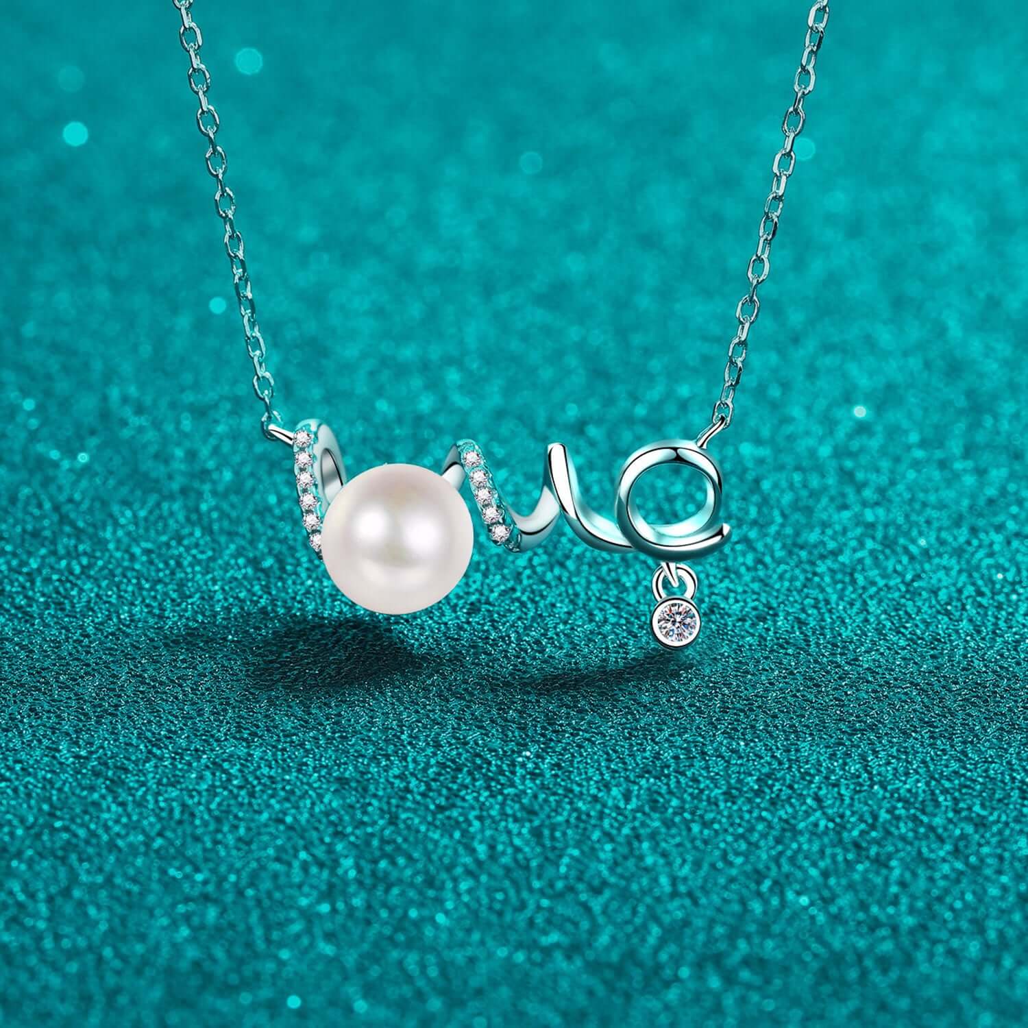 Elegant necklace with pearl and moissanite on 925 sterling silver chain, set against a sparkling teal background.