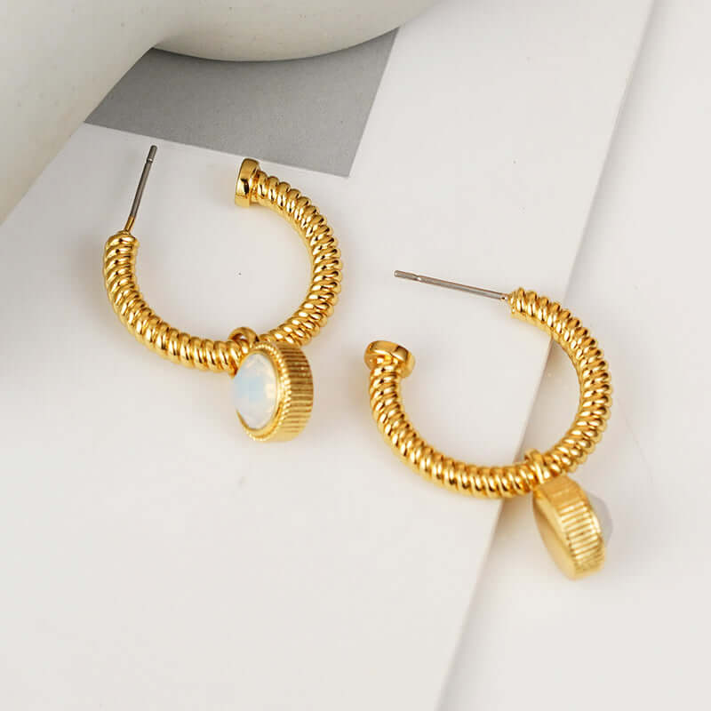 Gold-plated copper c-hoop earrings with cat's eye stones.