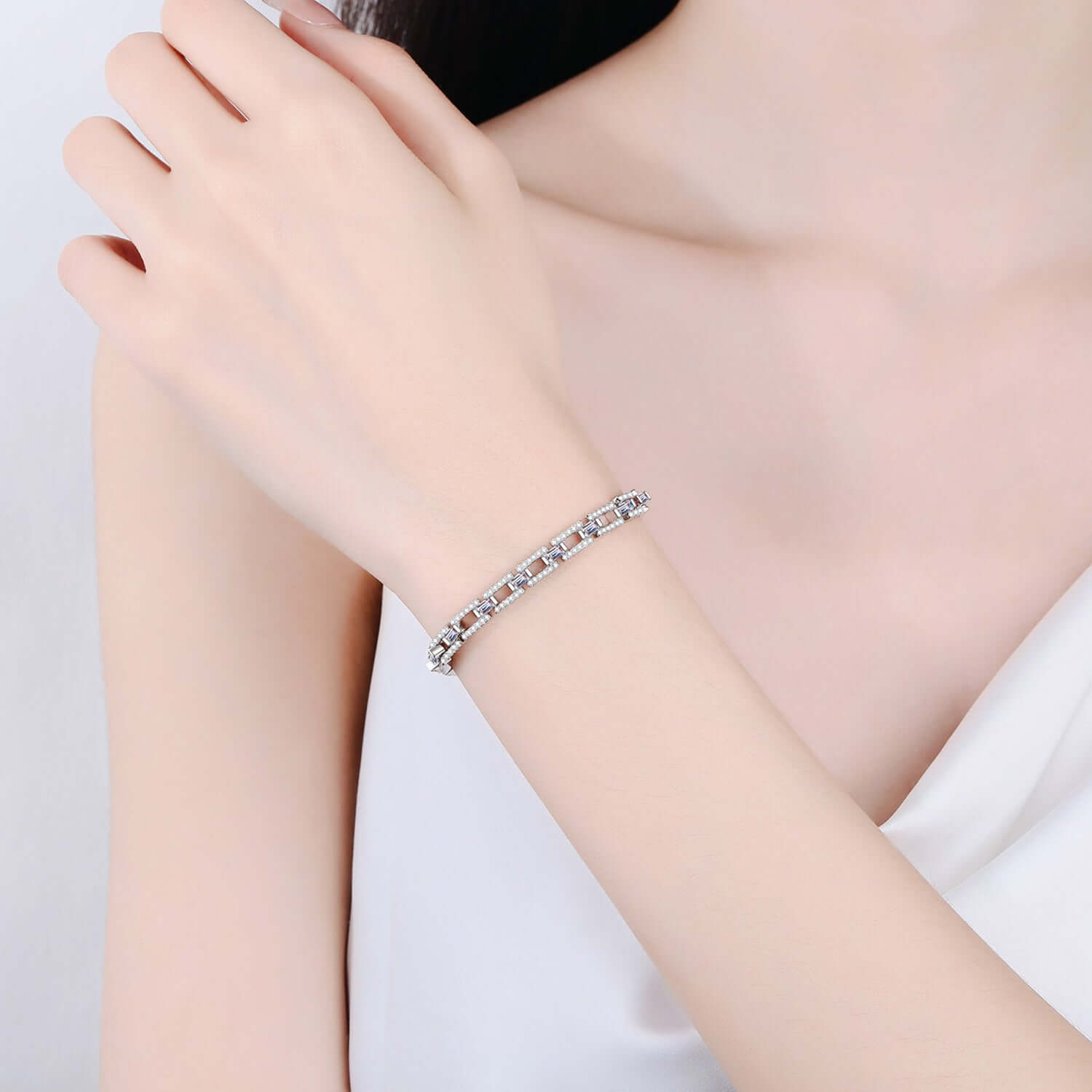 Woman wearing 3.2 carat moissanite bracelet in 925 sterling silver, elegant jewelry piece for special occasions.