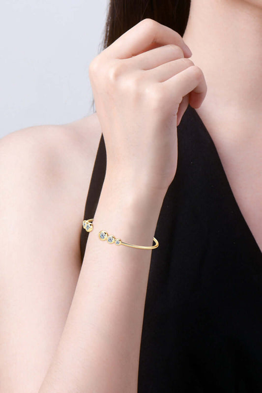 Woman wearing 1.8 carat moissanite bracelet in 925 sterling silver and gold-plated design.