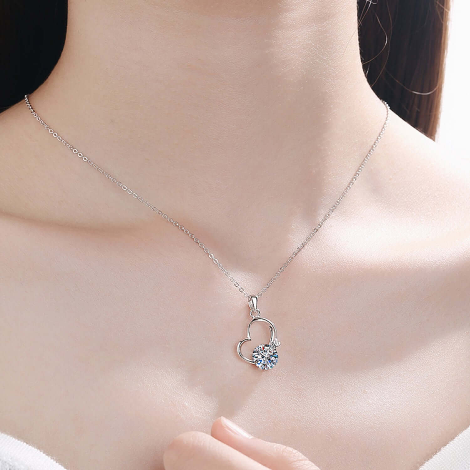 2 Carat Moissanite Heart Necklace in 925 Sterling Silver, showcasing elegant design on a woman's neck.