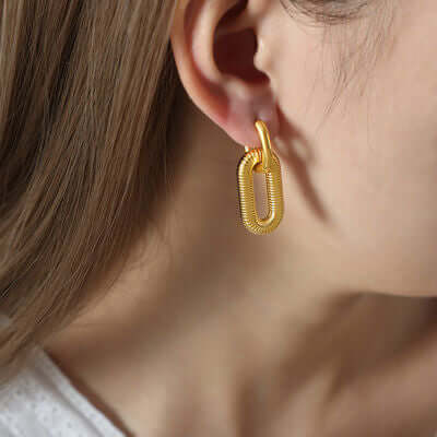 Woman wearing 18K gold-plated titanium steel dangle earring